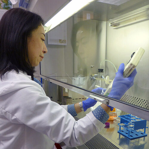 Female scientist in a lab conducting tests with lab equipment.