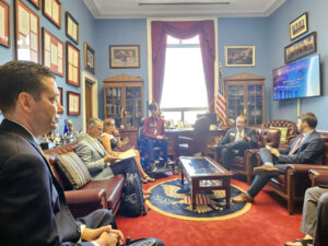 Chris Carrino and others sitting and conversing in a Capitol Hill building office